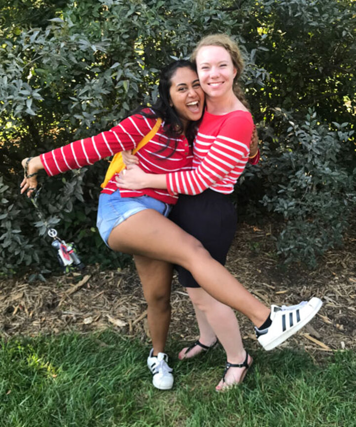 Mentor and mentee outside on the grass.