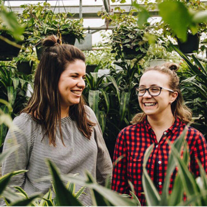 Mentor and mentee in a greenhouse